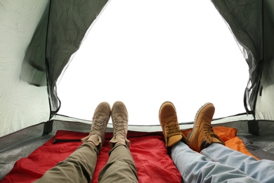 Closeup of couple in camping tent on white background, view from inside