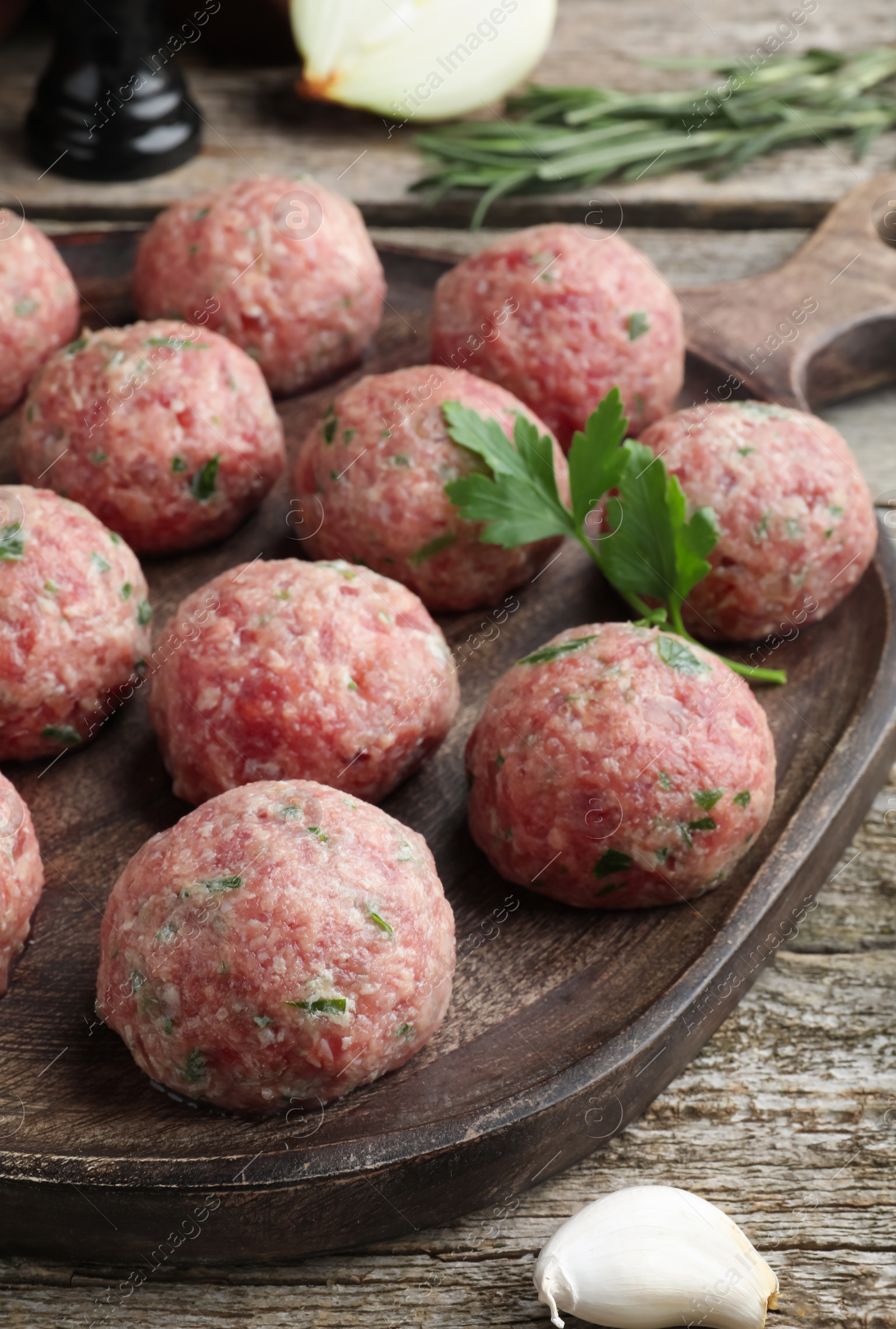 Photo of Many fresh raw meatballs on wooden table