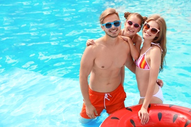 Photo of Happy family in pool on sunny day