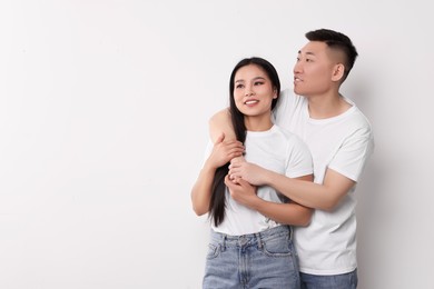 Portrait of happy couple on white background, space for text