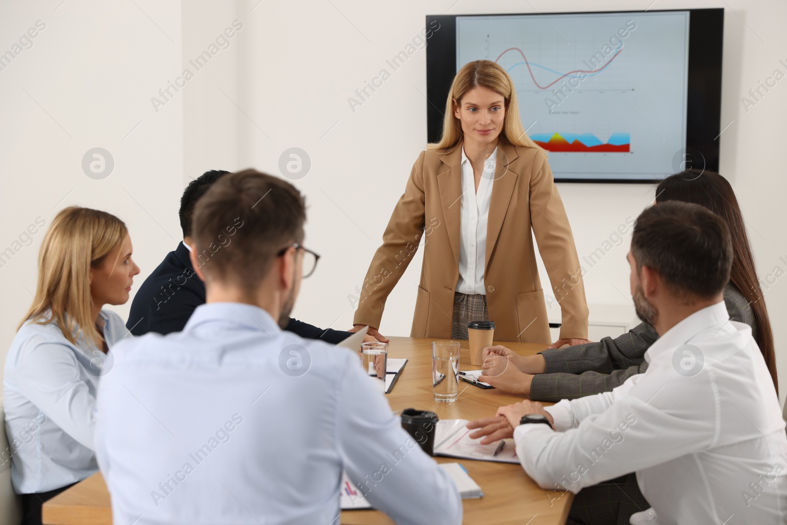 Photo of Businesswoman having meeting with her employees in office