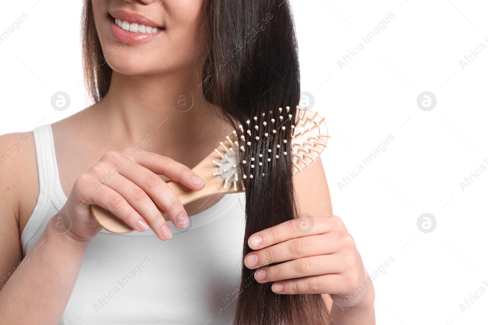 Photo of Woman with hair brush on white background, closeup