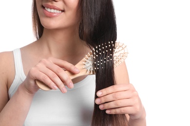 Photo of Woman with hair brush on white background, closeup