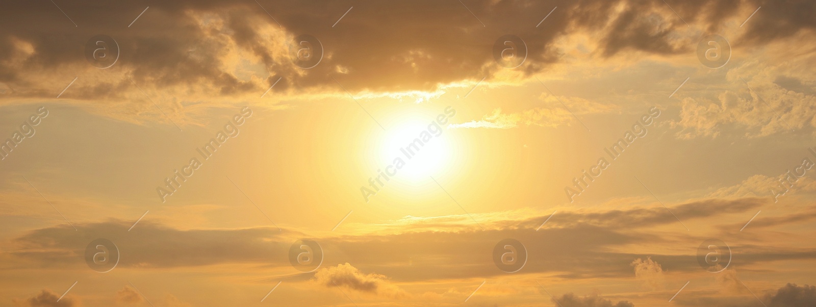 Image of Sun shining on beautiful cloudy sky at sunset, banner design