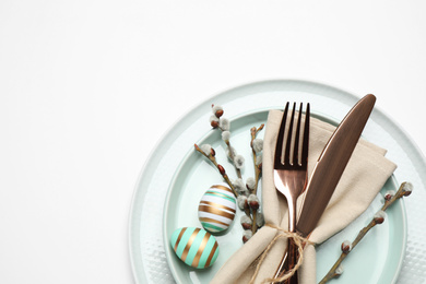 Festive Easter table setting with floral decor on white background, top view