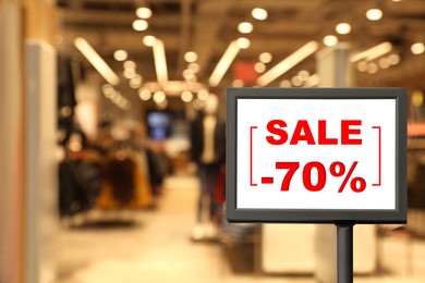 Image of Sign with text SALE and 70 percent discount in shopping mall. Special promotion
