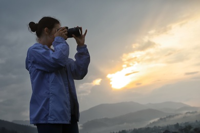 Photo of Professional nature photographer taking photos in mountains