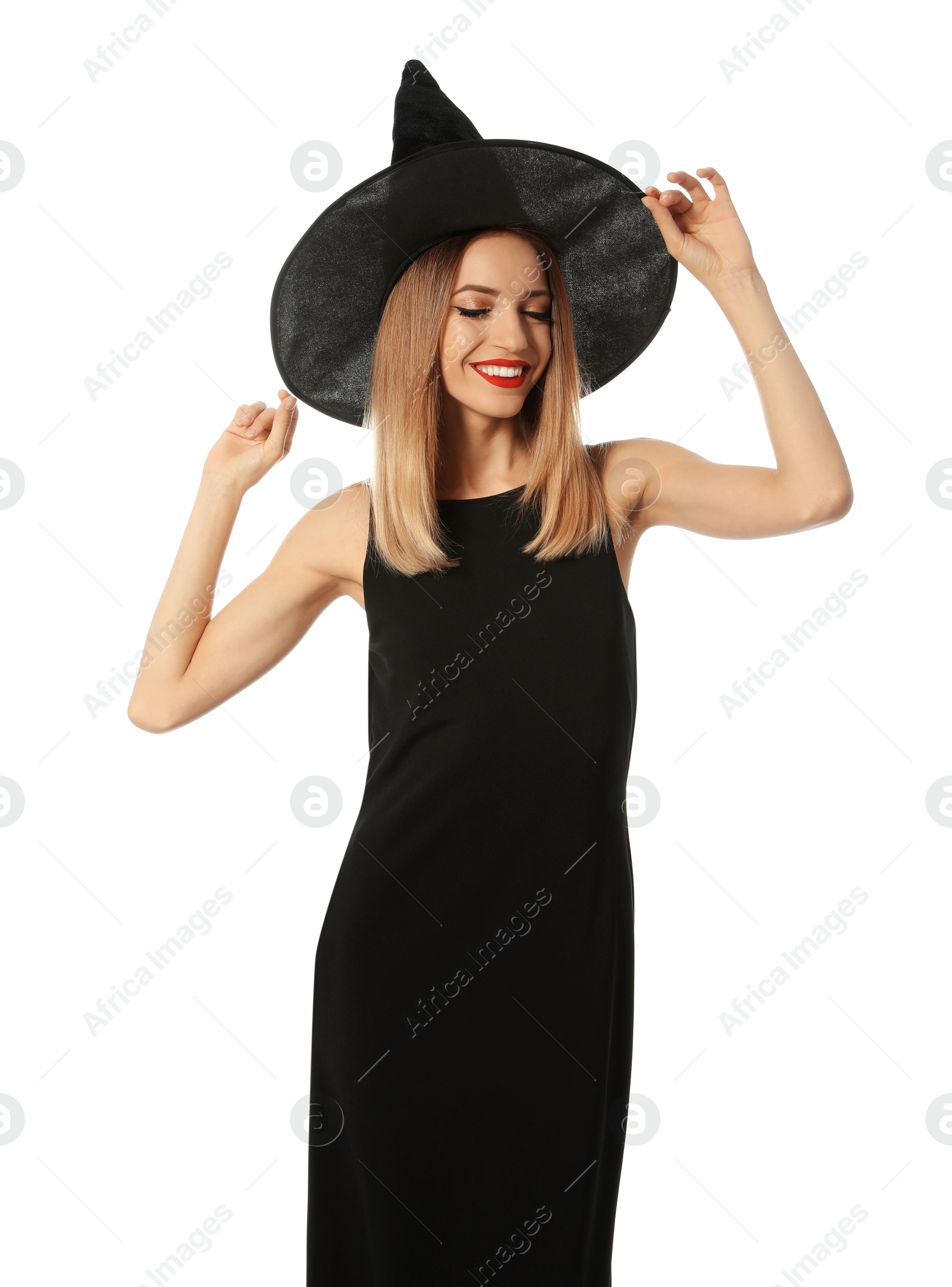 Photo of Beautiful young woman wearing witch costume for Halloween party on white background