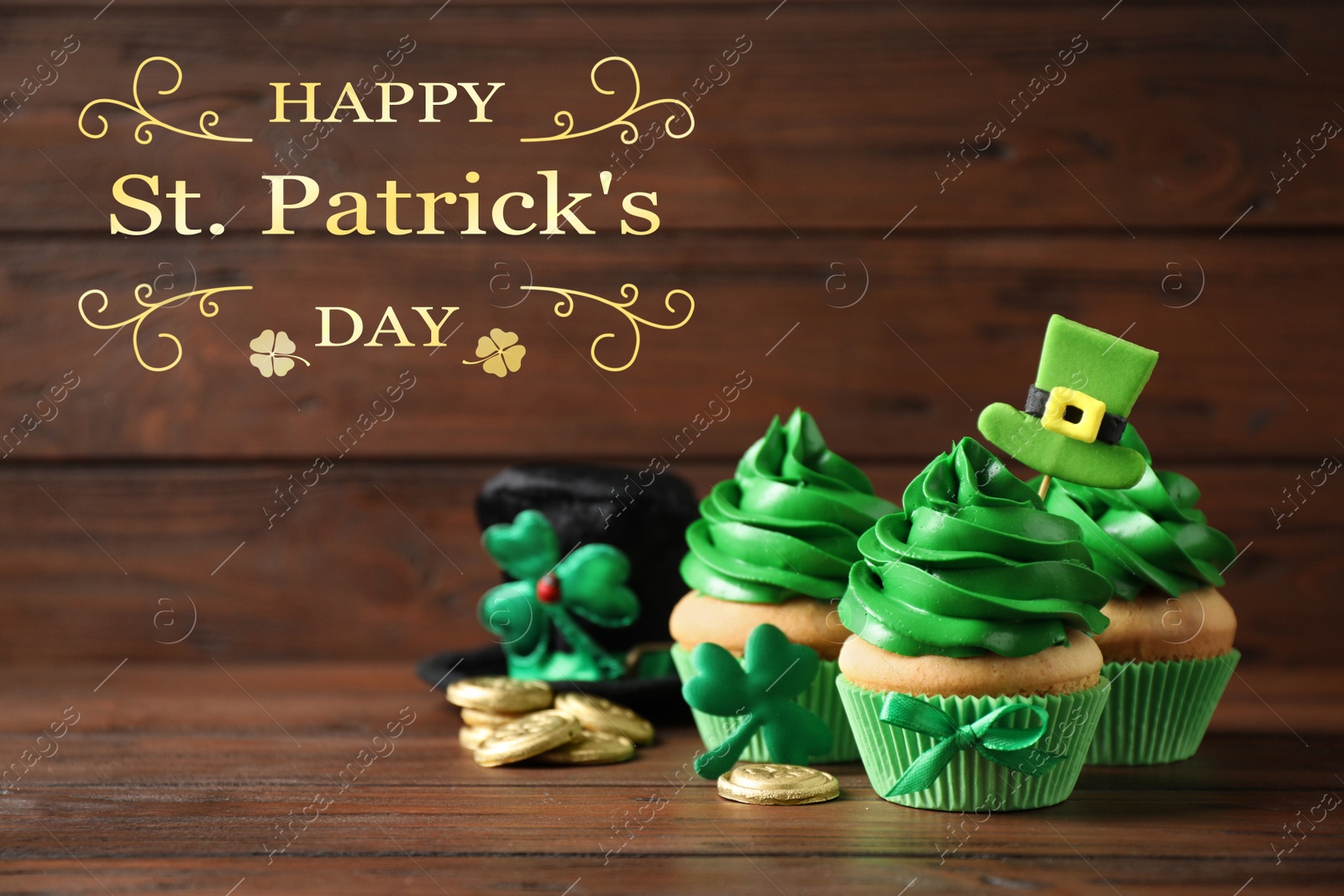 Image of Decorated cupcakes and coins on wooden table. St. Patrick's Day celebration