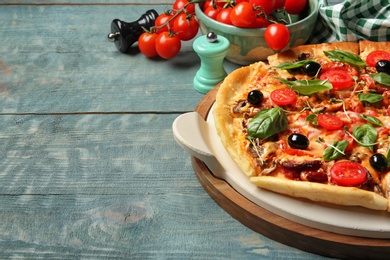 Tasty homemade pizza and space for text on wooden table
