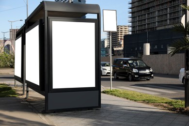 Bus stop with empty signboards in city. Mock-up for design