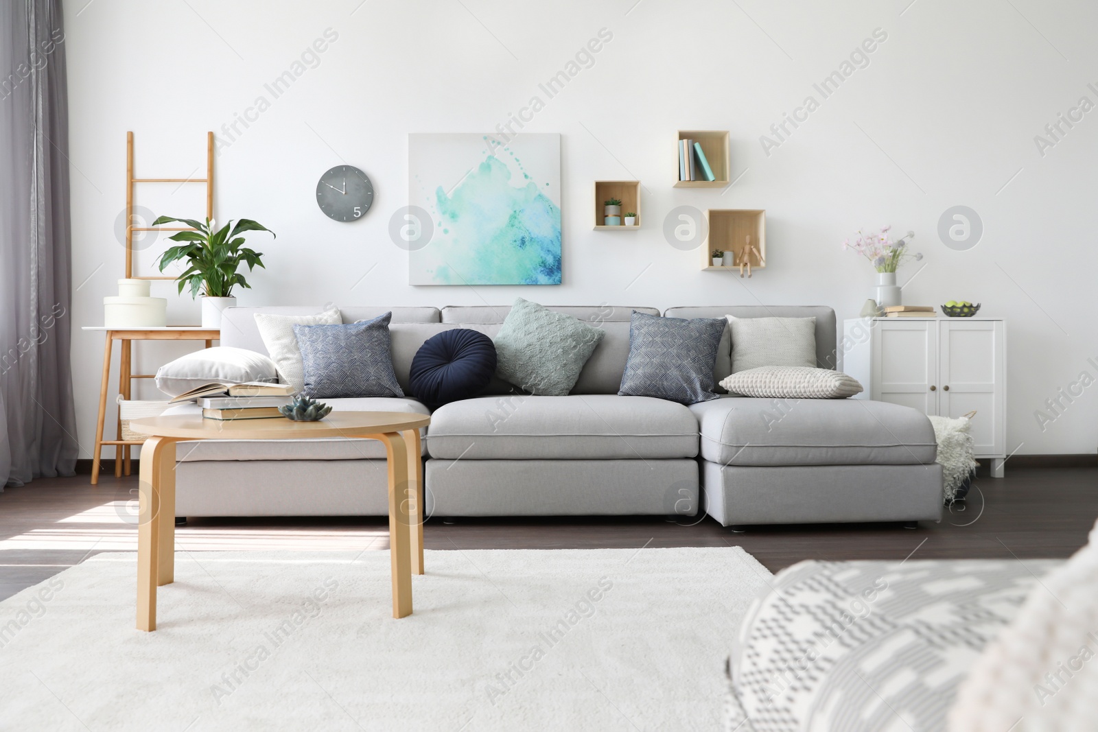 Photo of Elegant living room with comfortable sofa and wooden table. Interior design