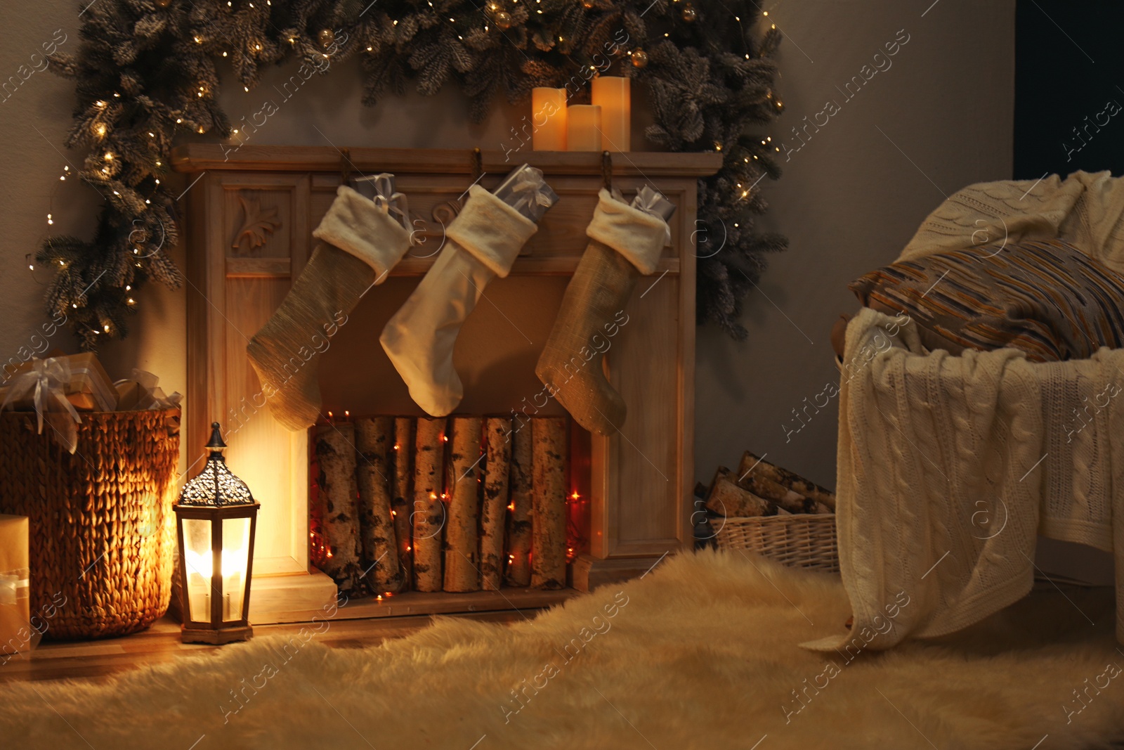 Photo of Fireplace with Christmas stockings in festive room interior