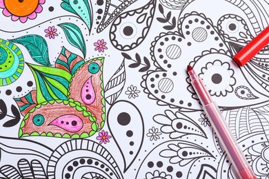 Photo of Felt tip pen on antistress coloring page, top view