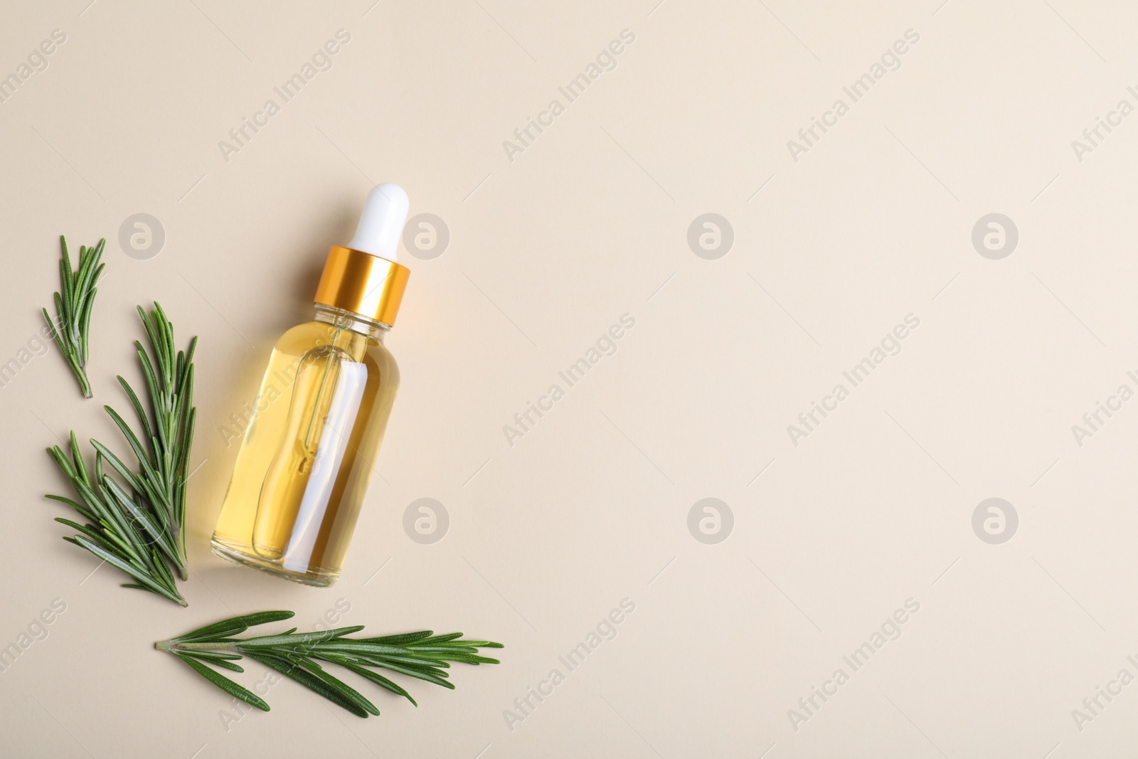 Photo of Flat lay composition with rosemary essential oil and space for text on beige background