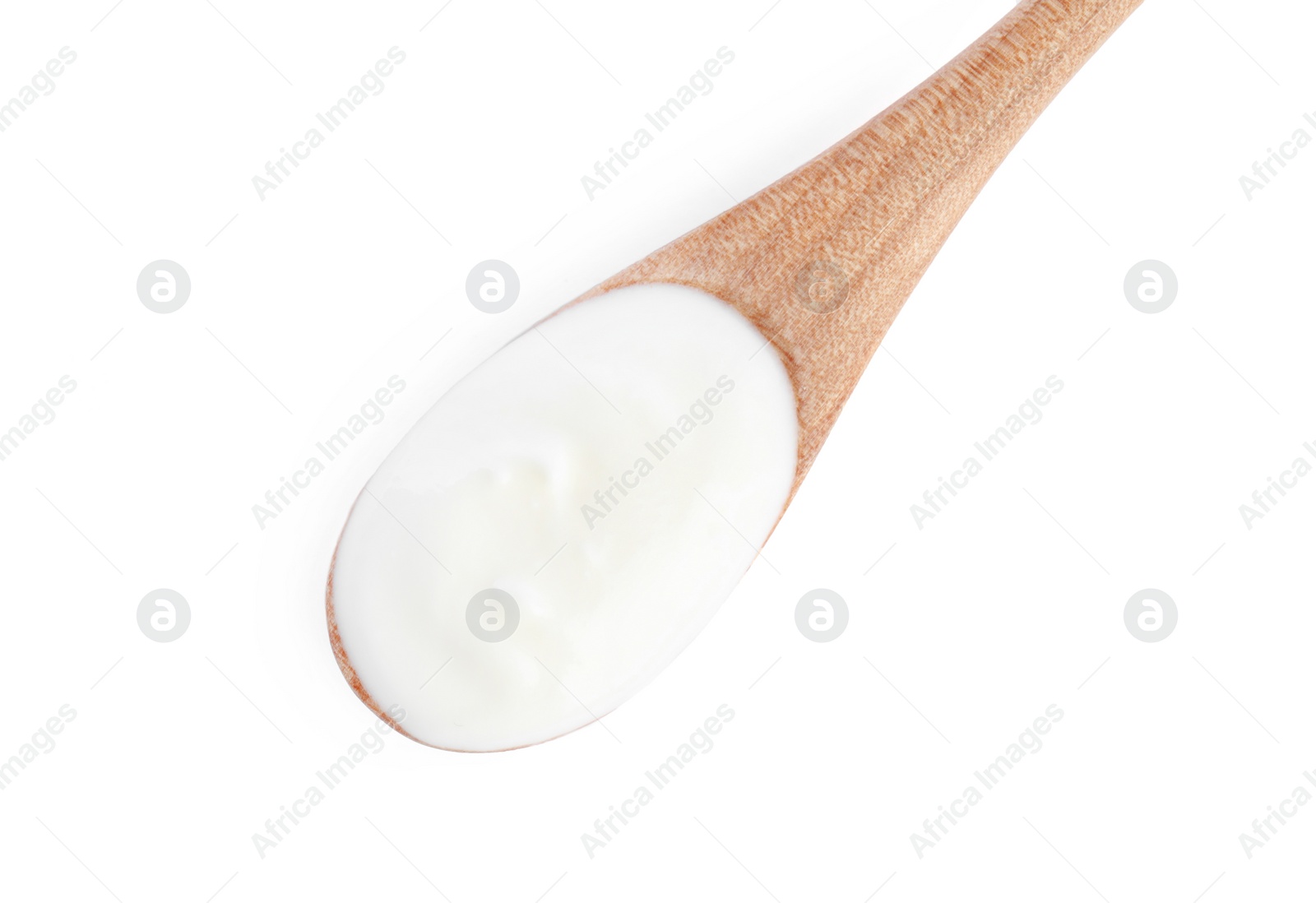 Photo of Wooden spoon with tasty organic yogurt isolated on white, top view