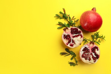 Photo of Flat lay composition with ripe pomegranates on yellow background. Space for text