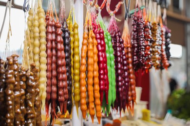 Photo of Bunches of different delicious churchkhelas at market