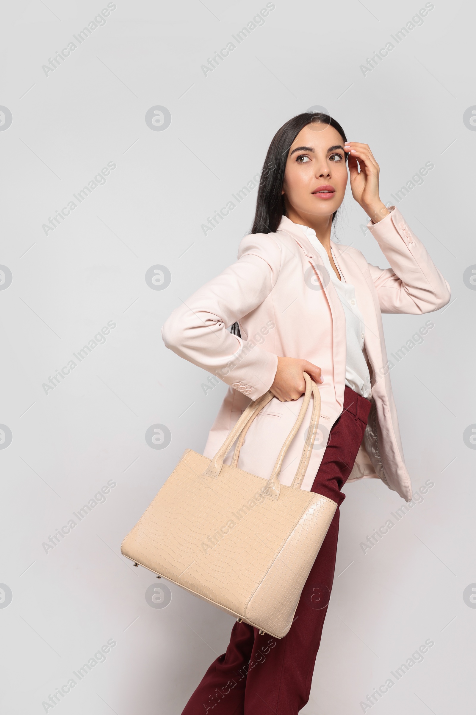 Photo of Young woman with stylish bag on white background