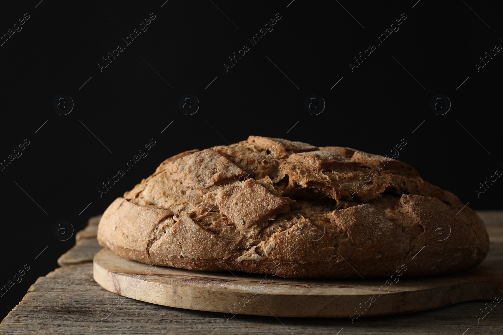 Photo of Freshly baked sourdough bread on wooden table