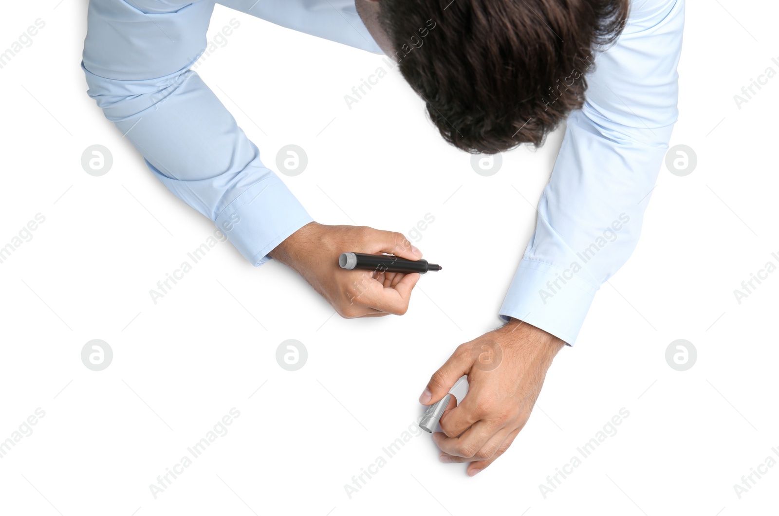 Photo of Man with marker on white background, top view. Closeup of hands