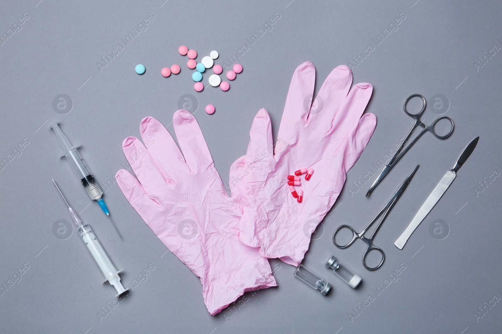 Photo of Flat lay composition with medical gloves on color background