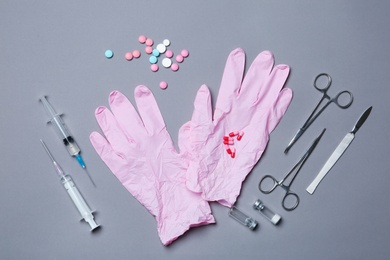Photo of Flat lay composition with medical gloves on color background