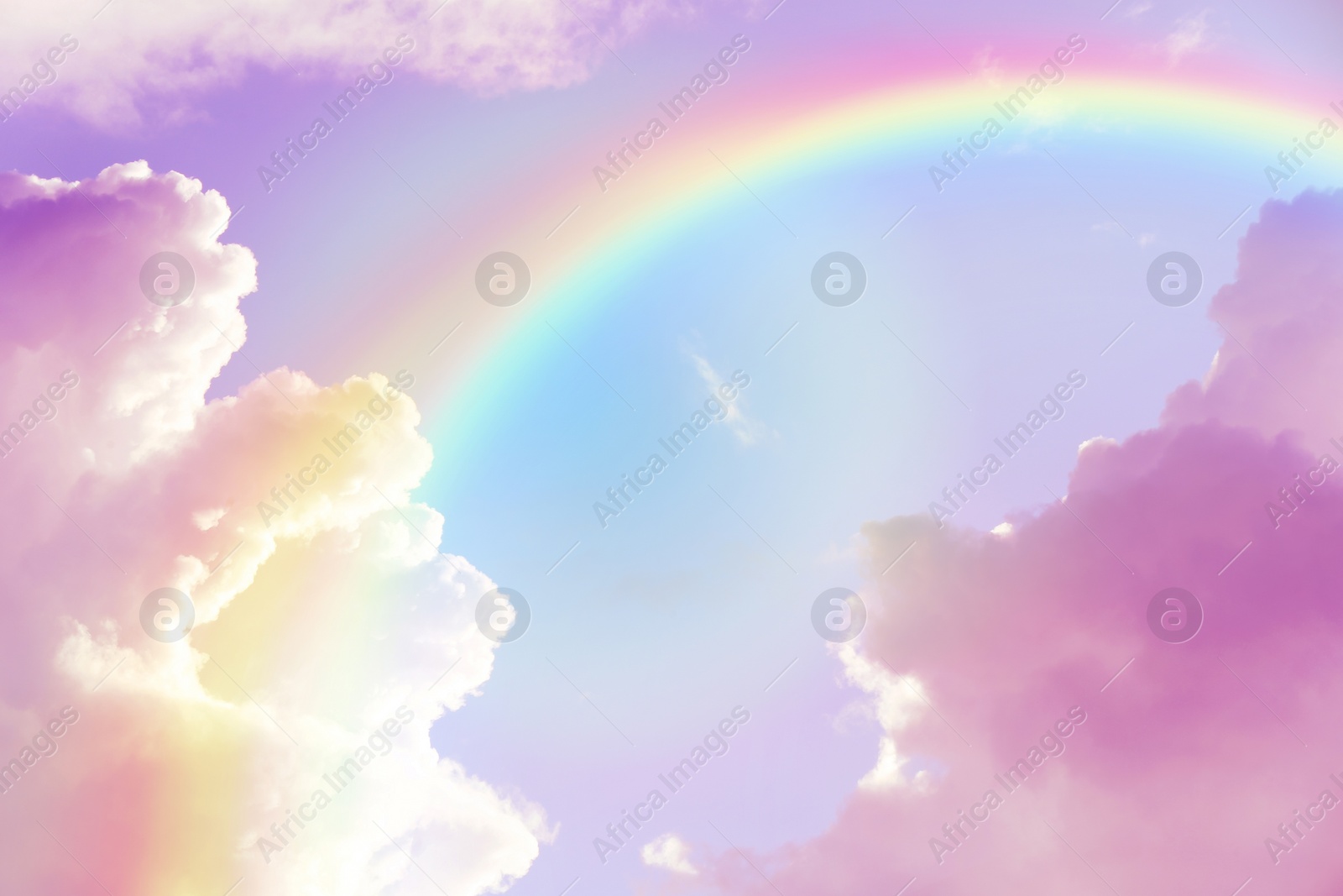 Image of Amazing sky with rainbow and fluffy clouds, toned in unicorn colors