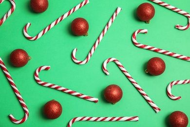 Photo of Flat lay composition with Christmas candy canes on color background