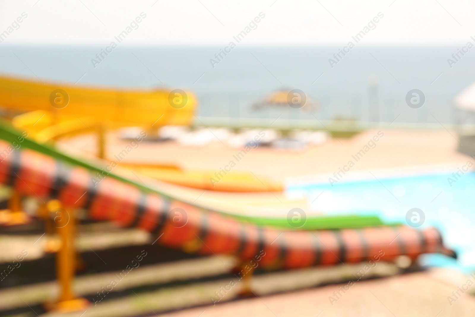 Photo of Different colorful slides in water park, blurred view