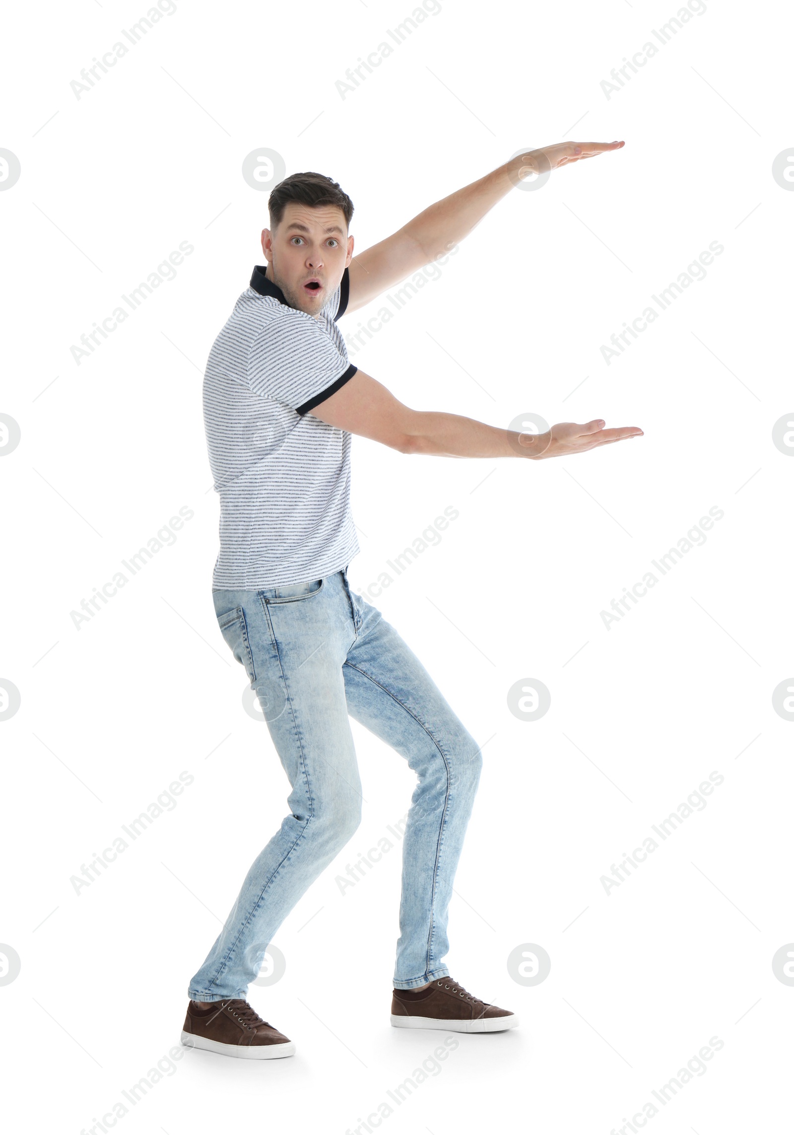 Photo of Emotional man in casual clothes holding something on white background