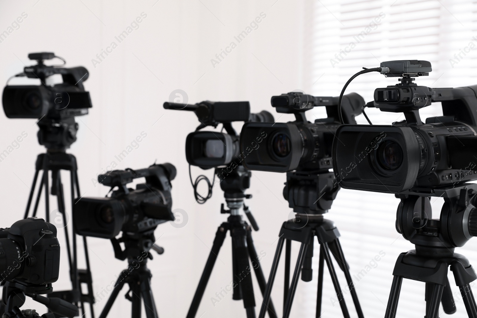 Photo of Modern video cameras indoors. Professional media equipment for broadcasting event