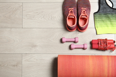 Photo of Set of fitness equipment and accessories on wooden background, flat lay. Space for text