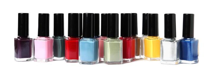 Bright nail polishes in bottles isolated on white