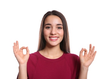 Photo of Woman showing OK gesture in sign language on white background