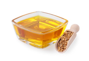 Photo of Bowl of natural oil and wooden scoop with mustard seeds on white background