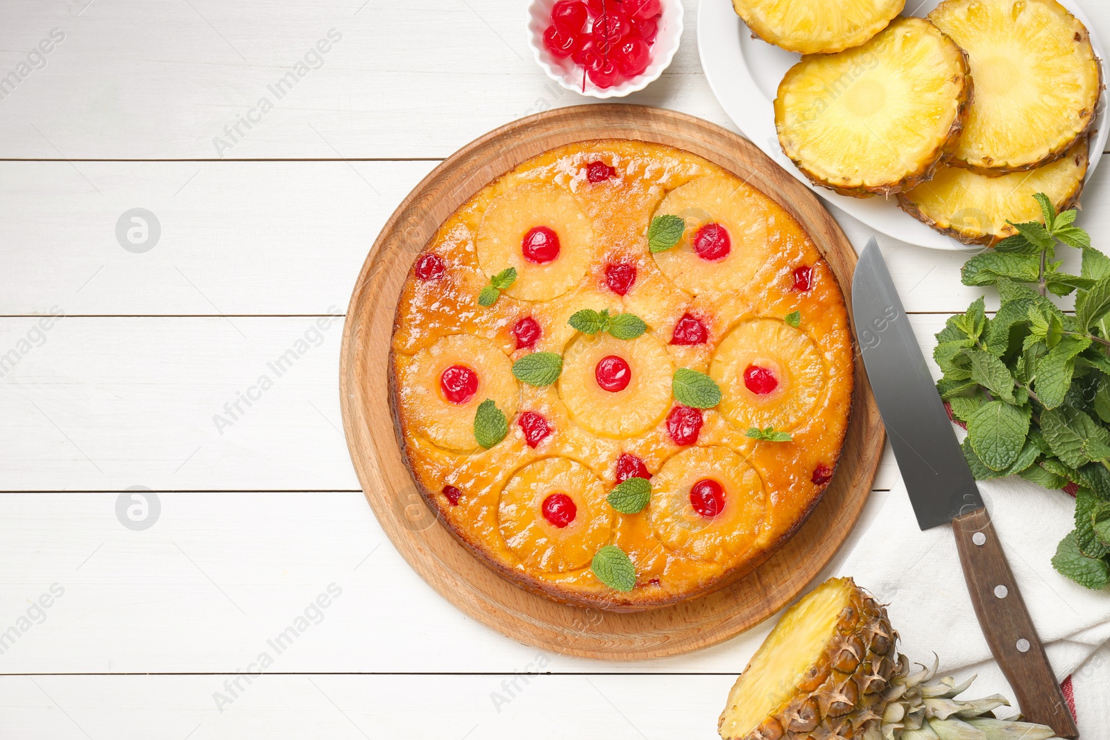 Photo of Delicious pineapple pie with cherry and mint on white wooden table, flat lay. Space for text