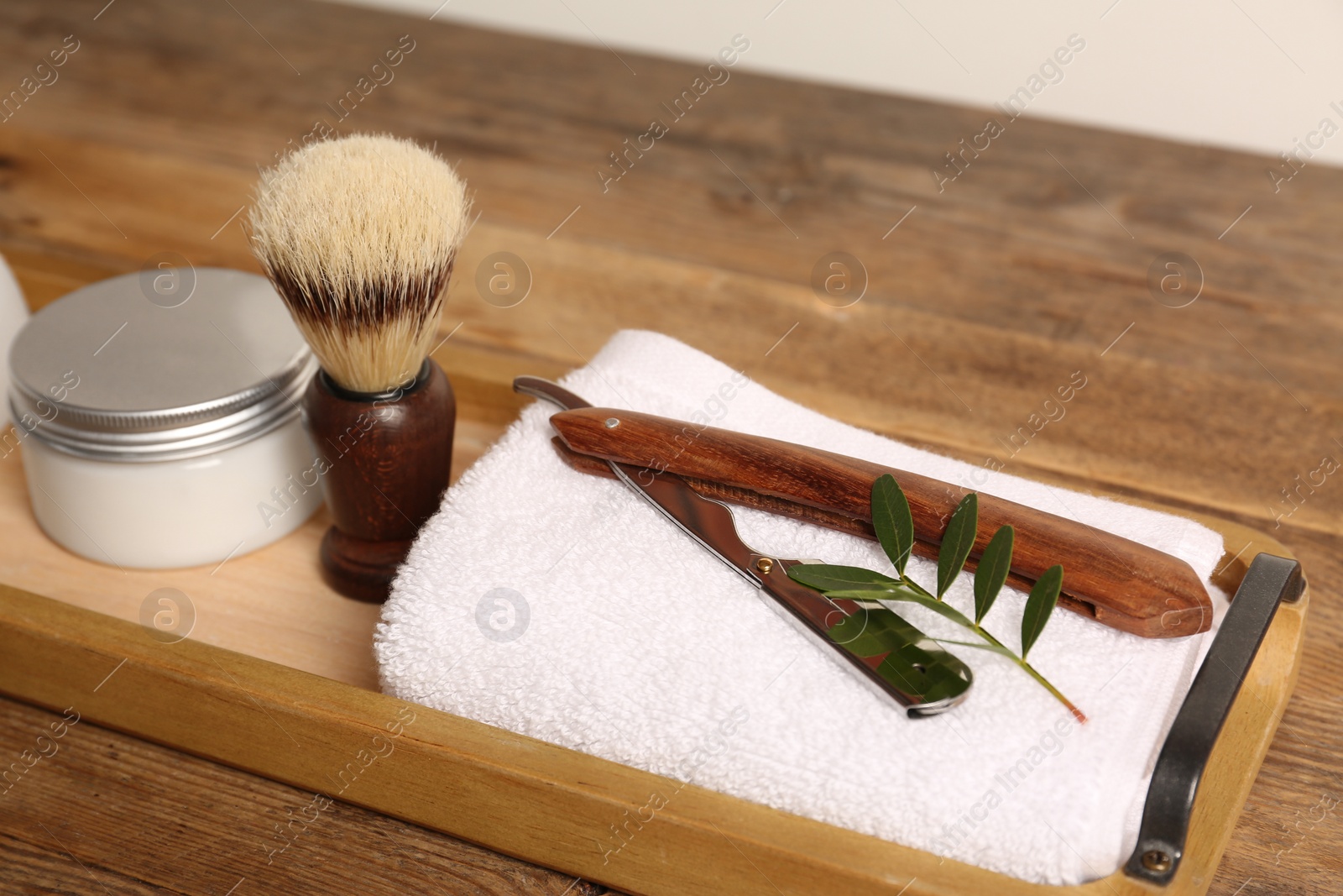 Photo of Set of men's shaving tools on wooden tray