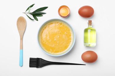 Photo of Homemade hair mask, brush and ingredients on white background, flat lay