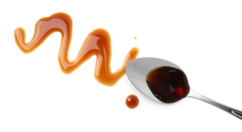 Photo of Tasty soy sauce and spoon isolated on white, top view
