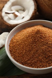 Natural coconut sugar in ceramic bowl on table, closeup