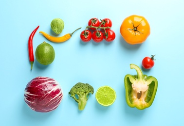 Flat lay composition with fresh vegetables and fruit on color background