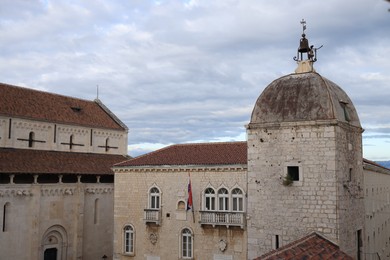 Trogir, Croatia - September 24, 2023: Picturesque view of old buildings against cloudy sky in city