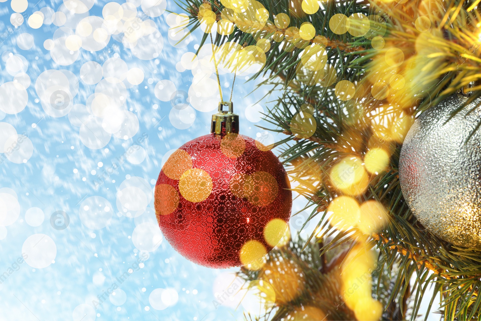 Image of Beautiful bauble hanging on Christmas tree against blurred lights, closeup view. Bokeh effect