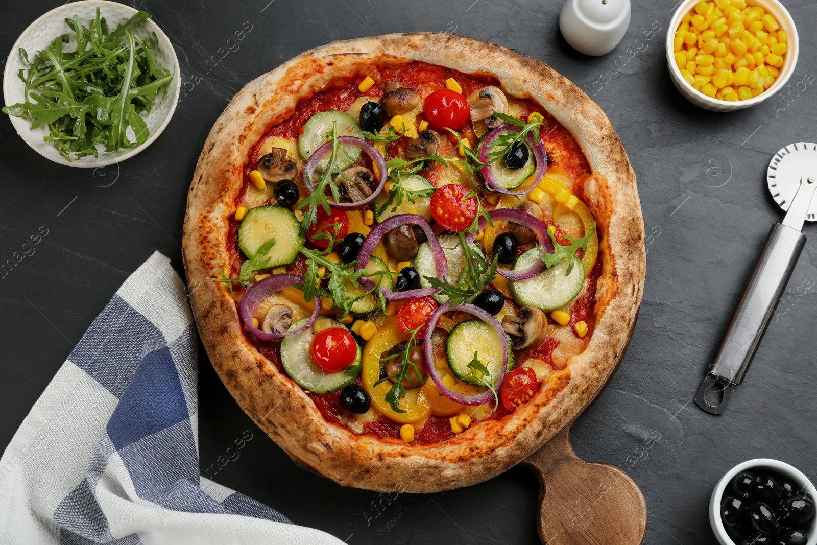 Photo of Flat lay composition with delicious hot vegetable pizza on black table