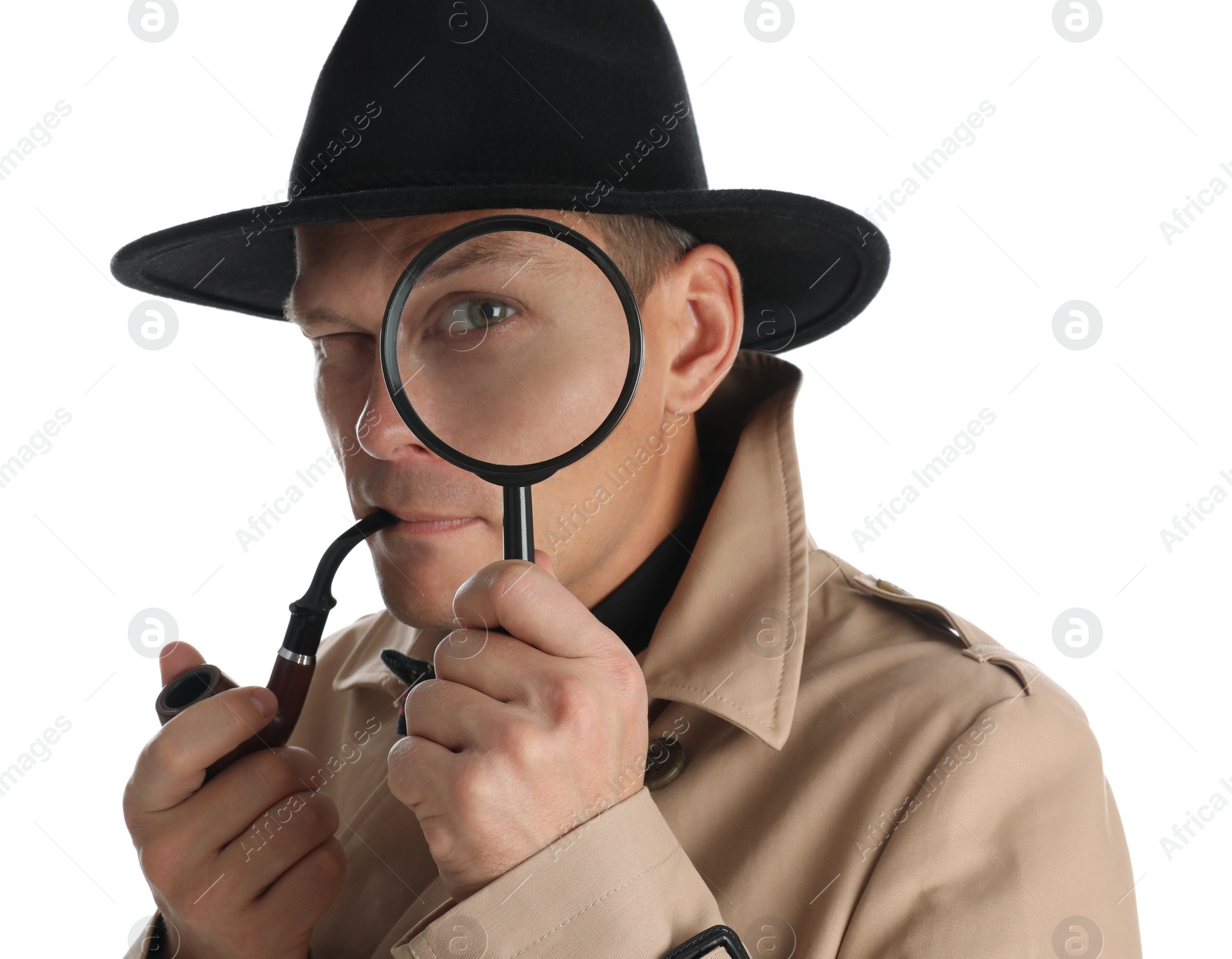 Photo of Male detective with smoking pipe looking through magnifying glass on white background