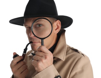 Photo of Male detective with smoking pipe looking through magnifying glass on white background