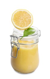 Photo of Delicious lemon curd in glass jar, fresh citrus fruit and green leaf isolated on white