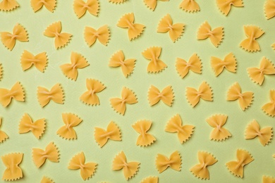 Photo of Flat lay composition with raw pasta on color background