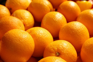 Photo of Heap of fresh oranges on counter at market, closeup